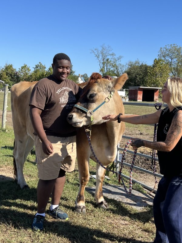 Veteran Kanye Reid, left makes friends with one of the farm animals at Courageous Hearts under the watchful eye of Bekah Baughman, a co-psychotherapist at the farm who facilitates sessions between animals and participants.